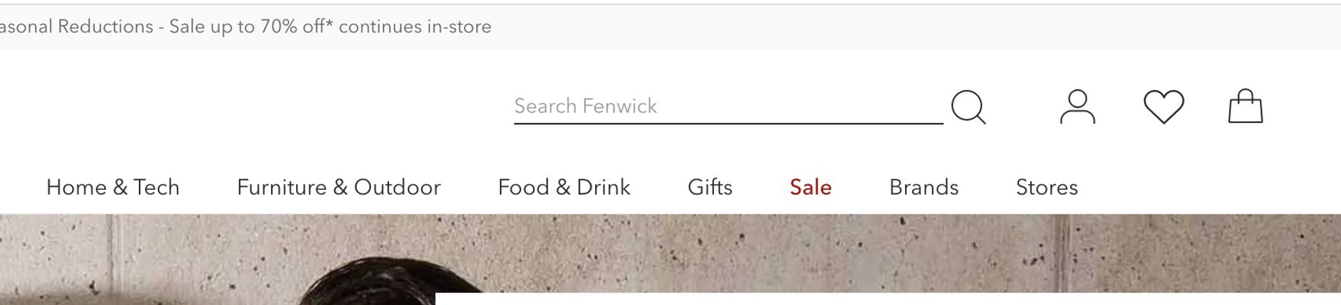 screenshot of the Fenwick homepage in August 2023, highlighting the text of the Search Bar that has a placeholder that reads, Search Fenwick. The poor colour constrast means it's not readable