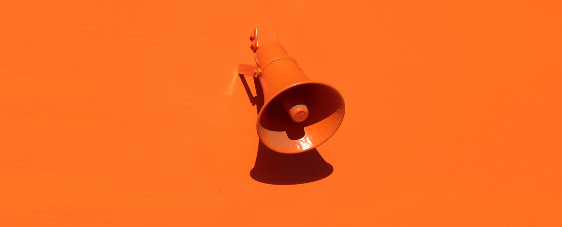 An orange megaphone on a orange background